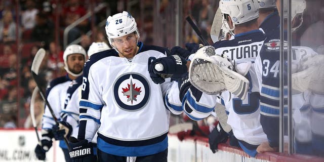 GLENDALE, AZ - OCTOBER 09: Blake Wheeler #26 of the Winnipeg Jets celebrates with teammates on the bench after scoring a first period goal against the Arizona Coyotes during the NHL game at Gila River Arena on October 9, 2014 in Glendale, Arizona. (Photo by Christian Petersen/Getty Images)