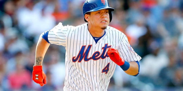 NEW YORK, NY - AUGUST 29: Wilmer Flores #4 of the New York Mets in action against the Boston Red Sox at Citi Field on August 29, 2015 in the Flushing neighborhood of the Queens borough of New York City. The Red Sox defeated the Mets 3-1. (Photo by Jim McIsaac/Getty Images)