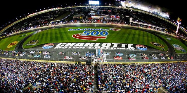 CHARLOTTE, NC - OCTOBER 11: Kyle Busch, driver of the #18 Doublemint Toyota, and Jeff Gordon, driver of the #24 Drive To End Hunger Chevrolet, lead the field to the green flag for the running of the NASCAR Sprint Cup Series Bank of America 500 at Charlotte Motor Speedway on October 11, 2014 in Charlotte, North Carolina. (Photo by Streeter Lecka/Getty Images)