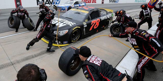DOVER, DE - OCTOBER 04: Martin Truex Jr., driver of the #78 Furniture Row/Visser Precision Chevrolet, pits during the NASCAR Sprint Cup Series AAA 400 at Dover International Speedway on October 4, 2015 in Dover, Delaware. (Photo by Jerry Markland/Getty Images)