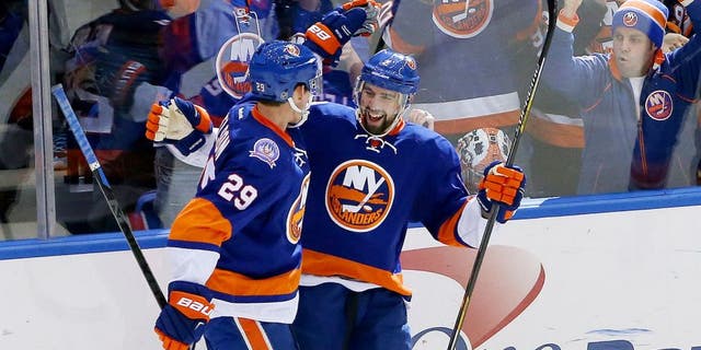 Feb 19, 2015; Uniondale, NY, USA; New York Islanders defenseman Nick Leddy (2) celebrates his goal with center Brock Nelson (29) during the third period against the Nashville Predators at Nassau Veterans Memorial Coliseum. New York Islanders won 5-2. Mandatory Credit: Anthony Gruppuso-USA TODAY Sports