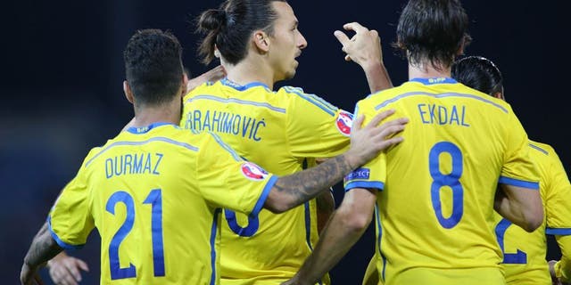 Swedens Zlatan Ibrahimovic (2nd L) celebrates with teammates Jimmy Durmaz (L) and Albin Ekdal after scoring his team's second goal during the Euro 2016 Group G qualifying football match between Liechtenstein and Sweden at the Rheinpark stadium in Vaduz on October 9, 2015. AFP PHOTO / MICHELE LIMINA (Photo credit should read MICHELE LIMINA/AFP/Getty Images)