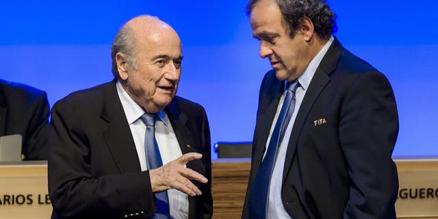 FIFA president Joseph Blatter talks to UEFA president Michel Platini during the 64th FIFA congress on June 11, 2014 in Sao Paulo, on the eve of the opening match of the 2014 FIFA World Cup in Brazil. AFP PHOTO / FABRICE COFFRINI (Photo credit should read FABRICE COFFRINI/AFP/Getty Images)