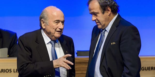 FIFA president Joseph Blatter talks to UEFA president Michel Platini during the 64th FIFA congress on June 11, 2014 in Sao Paulo, on the eve of the opening match of the 2014 FIFA World Cup in Brazil. AFP PHOTO / FABRICE COFFRINI (Photo credit should read FABRICE COFFRINI/AFP/Getty Images)