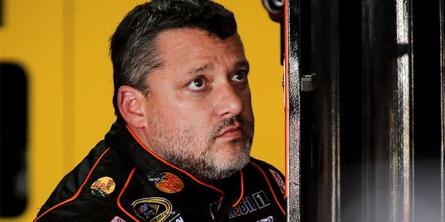 CHARLOTTE, NC - OCTOBER 08: Tony Stewart, driver of the #14 Bass Pro Shops/Mobil 1 Chevrolet, stis in the garage during practice for the NASCAR Sprint Cup Series Bank of America 500 at Charlotte Motor Speedway on October 8, 2015 in Charlotte, North Carolina. (Photo by Jerry Markland/Getty Images)