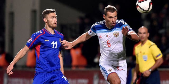 Russia's defender Aleksei Berezutski (R) vies Moldova's forward Nicolae Milinceanu during the Euro 2016 qualifying football match between Russia and Moldova at the Stadionul Zimbru in Chisinau on October 9, 2015. AFP PHOTO / KIRILL KUDRYAVTSEV (Photo credit should read KIRILL KUDRYAVTSEV/AFP/Getty Images)