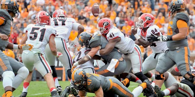 Oct 10, 2015; Knoxville, TN, USA; Tennessee Volunteers running back Jalen Hurd (1) fumbles as he is tackled by Georgia Bulldogs linebacker Chuks Amaechi (41) during the first half at Neyland Stadium. The ball was recovered by Georgia linebacker Leonard Floyd (84) and returned for a touchdown. Mandatory Credit: Jim Brown-USA TODAY Sports