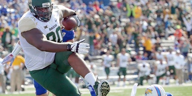 Baylor tight end LaQuan McGowan (80) gets past Kansas safety Michael Glatczak (39) to score a touchdown during the first half of an NCAA college football game, Saturday, Oct. 10, 2015, in Lawrence, Kan. (AP Photo/Charlie Riedel)