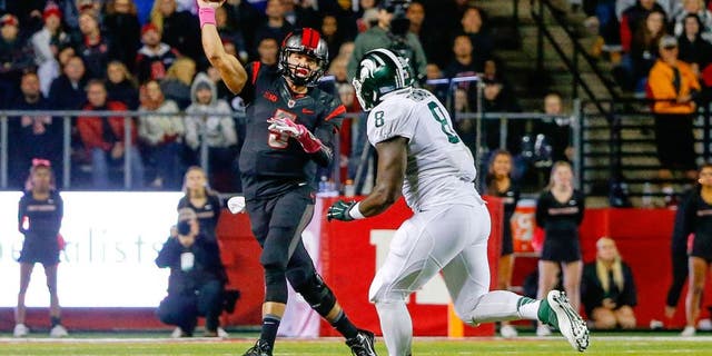 Oct 10, 2015; Piscataway, NJ, USA; Rutgers Scarlet Knights quarterback Chris Laviano (5) gets off pass as he is rushed by Michigan State Spartans defensive lineman Lawrence Thomas (8) during the first quarter at High Points Solutions Stadium. Mandatory Credit: Jim O'Connor-USA TODAY Sports