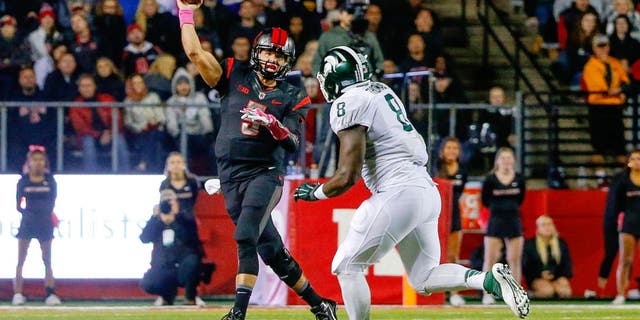 Oct 10, 2015; Piscataway, NJ, USA; Rutgers Scarlet Knights quarterback Chris Laviano (5) gets off pass as he is rushed by Michigan State Spartans defensive lineman Lawrence Thomas (8) during the first quarter at High Points Solutions Stadium. Mandatory Credit: Jim O'Connor-USA TODAY Sports
