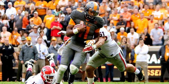 Oct 10, 2015; Knoxville, TN, USA; Tennessee Volunteers quarterback Joshua Dobbs (11) runs for a touchdown against the Georgia Bulldogs during the second half at Neyland Stadium. Mandatory Credit: Randy Sartin-USA TODAY Sports