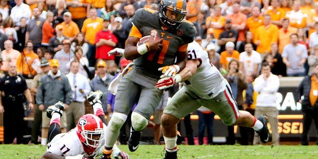 Oct 10, 2015; Knoxville, TN, USA; Tennessee Volunteers quarterback Joshua Dobbs (11) runs for a touchdown against the Georgia Bulldogs during the second half at Neyland Stadium. Mandatory Credit: Randy Sartin-USA TODAY Sports