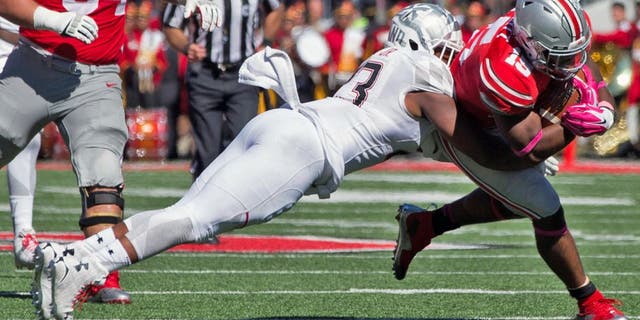 Oct 10, 2015; Columbus, OH, USA; Maryland Terrapins linebacker Jermaine Carter Jr. (23) tackles Ohio State Buckeyes running back Ezekiel Elliott (15) at Ohio Stadium. Mandatory Credit: Greg Bartram-USA TODAY Sports