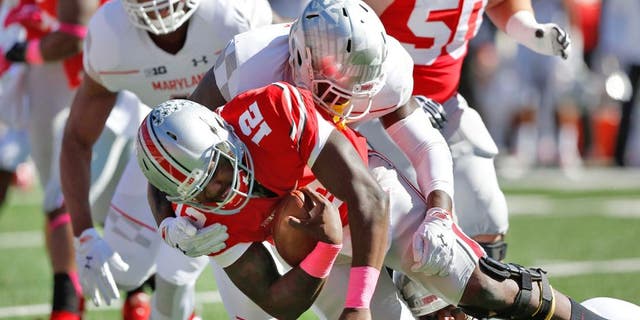 Oct 10, 2015; Columbus, OH, USA; Ohio State Buckeyes quarterback Cardale Jones (12) is sacked by Maryland Terrapins defensive lineman Yannick Ngakoue (7) during the first quarter at Ohio Stadium. Mandatory Credit: Joe Maiorana-USA TODAY Sports