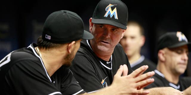Oct 1, 2015; St. Petersburg, FL, USA; Miami Marlins manager Dan Jennings (26) talks with starting pitcher Jose Fernandez (16) during the fourth inning against the Tampa Bay Rays at Tropicana Field. Mandatory Credit: Kim Klement-USA TODAY Sports