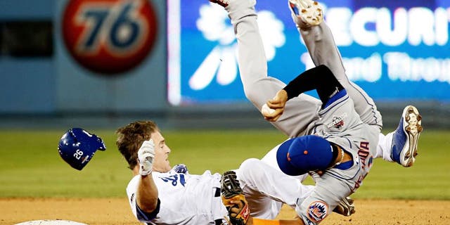 LOS ANGELES, CA - OCTOBER 10: Ruben Tejada #11 of the New York Mets is hit by a slide by Chase Utley #26 of the Los Angeles Dodgers in the seventh inning in an attempt to turn a double play in game two of the National League Division Series at Dodger Stadium on October 10, 2015 in Los Angeles, California. (Photo by Sean M. Haffey/Getty Images)