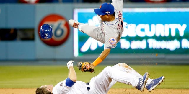 LOS ANGELES, CA - OCTOBER 10: Ruben Tejada #11 of the New York Mets is hit by a slide by Chase Utley #26 of the Los Angeles Dodgers in the seventh inning in an attempt to turn a double play in game two of the National League Division Series at Dodger Stadium on October 10, 2015 in Los Angeles, California. (Photo by Sean M. Haffey/Getty Images)