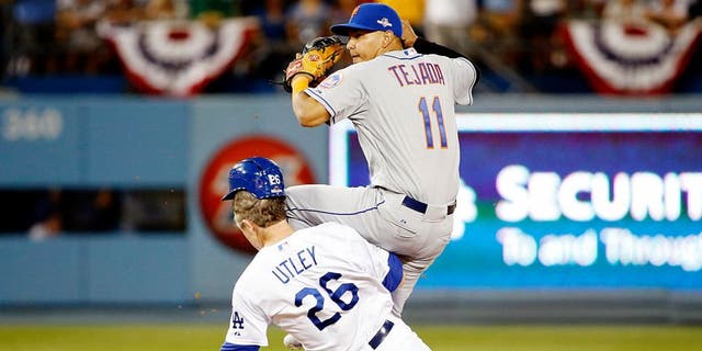 LOS ANGELES, CA - OCTOBER 10: Ruben Tejada #11 of the New York Mets is hit by a slide by Chase Utley #26 of the Los Angeles Dodgers in the seventh inning in an attempt to turn a double play in game two of the National League Division Series at Dodger Stadium on October 10, 2015 in Los Angeles, California. (Photo by Sean M. Haffey/Getty Images)