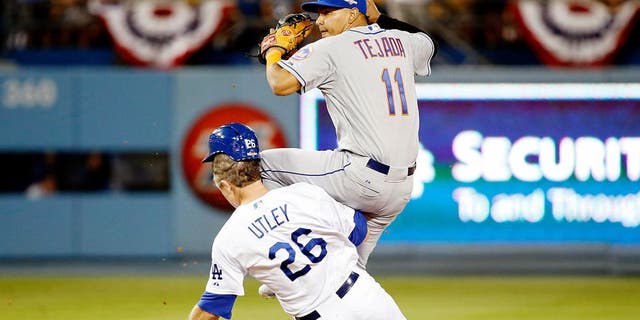 LOS ANGELES, CA - OCTOBER 10: Ruben Tejada #11 of the New York Mets is hit by a slide by Chase Utley #26 of the Los Angeles Dodgers in the seventh inning in an attempt to turn a double play in game two of the National League Division Series at Dodger Stadium on October 10, 2015 in Los Angeles, California. (Photo by Sean M. Haffey/Getty Images)
