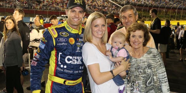USA -Oct 11: David Ragan, driver of the #34 CSX - Play It Safe Ford Fusion, poses for a photo with his wife Jacquelyn and family prior to the start of the NASCAR Sprint Cup Series Bank of America 500 at the Charlotte Motor Speedway in Concord, NC. Picture taken on Oct 11, 2014 in the United States. (Photo by Jim Fluharty/NASCAR Illustrated/Sporting News via Getty Images)