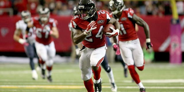 Oct 4, 2015; Atlanta, GA, USA; Atlanta Falcons running back Devonta Freeman (24) runs after a catch in the second quarter of their game against the Houston Texans at the Georgia Dome. The Falcons won 48-21. Mandatory Credit: Jason Getz-USA TODAY Sports
