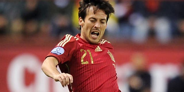 LOGRONO, SPAIN - OCTOBER 09: David Silva of Spain is fouled by Lars Gerson of Luxembourg during the UEFA EURO 2016 Qualifier group C match between Spain and Luxembourg at Estadio Municipal Las Gaunas on October 9, 2015 in Logrono, Spain. (Photo by Denis Doyle/Getty Images)