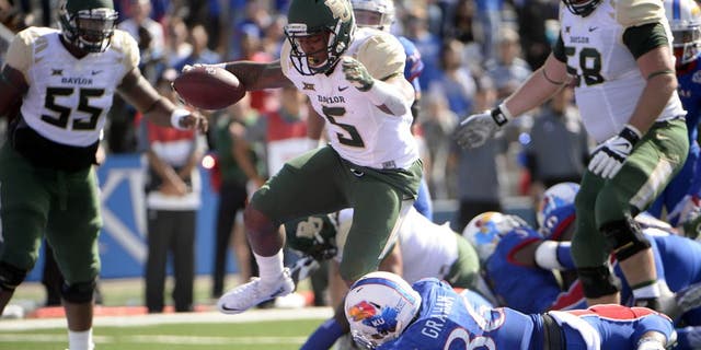 Oct 10, 2015; Lawrence, KS, USA; Baylor Bears running back Johnny Jefferson (5) rushes for a touchdown against Kansas Jayhawks cornerback Chevy Graham (36) in the first half at Memorial Stadium. Mandatory Credit: John Rieger-USA TODAY Sports
