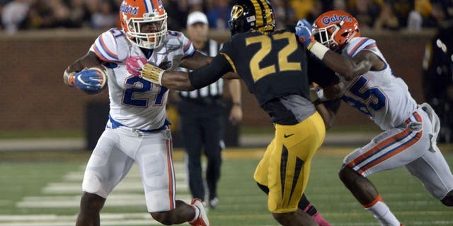 Oct 10, 2015; Columbia, MO, USA; Florida Gators running back Kelvin Taylor (21) runs the ball as Missouri Tigers defensive back Anthony Sherrils (22) defends during the first half at Faurot Field. Mandatory Credit: Denny Medley-USA TODAY Sports
