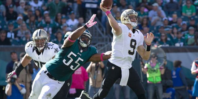 Oct 11, 2015; Philadelphia, PA, USA; New Orleans Saints quarterback Drew Brees (9) passes against the defensive rush of Philadelphia Eagles outside linebacker Brandon Graham (55) during the third quarter at Lincoln Financial Field. Mandatory Credit: Bill Streicher-USA TODAY Sports