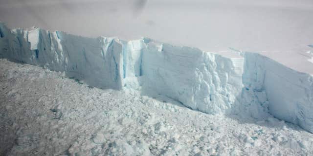 January 18, 2009: A 20 metre-high ice cliff forming the edge of the Wilkins Ice shelf on the Antarctic Peninsula is seen from a plane.