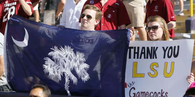 Oct. 10, 2015: Fans hold a signs in support of South Carolina during the first half of an NCAA college football game between LSU and South Carolina in Baton Rouge, La.