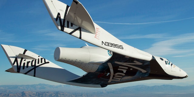 Oct. 10: In this photo released by Virgin Galactic, the Virgin Galactic SpaceShipTwo, or VSS Enterprise, glides toward the earth on its first test flight after release from the mothership, WhiteKnight2, also known as VMS Eve, over the Mojave, Calif., area.
