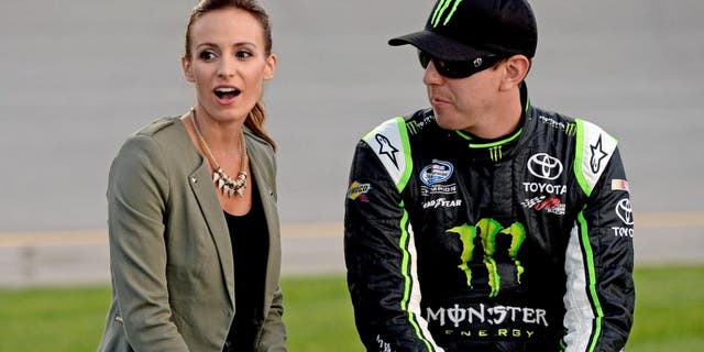 RICHMOND, VA - SEPTEMBER 06: (R-L) Kyle Busch, driver of the #54 Monster Energy Toyota, and wife Samantha Busch take part in pre-race ceremonies for the NASCAR Nationwide Series Virginia 529 College Savings 250 at Richmond International Raceway on September 6, 2013 in Richmond, Virginia. (Photo by Patrick Smith/Getty Images)