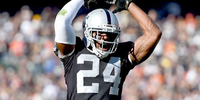 OAKLAND, CA - NOVEMBER 09: Charles Woodson #24 of the Oakland Raiders celebrates after the Raiders stopped the Denver Broncos on third an goal during the first quarter at O.co Coliseum on November 9, 2014 in Oakland, California. (Photo by Thearon W. Henderson/Getty Images)
