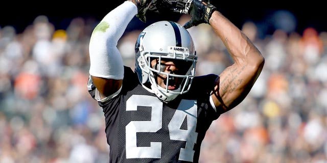 OAKLAND, CA - NOVEMBER 09: Charles Woodson #24 of the Oakland Raiders celebrates after the Raiders stopped the Denver Broncos on third an goal during the first quarter at O.co Coliseum on November 9, 2014 in Oakland, California. (Photo by Thearon W. Henderson/Getty Images)