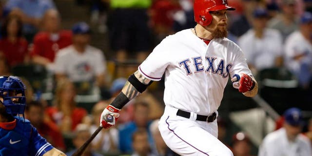 Oct 11, 2015; Arlington, TX, USA; Texas Rangers left fielder Josh Hamilton hits a single against the Toronto Blue Jays in the fifth inning in game three of the ALDS at Globe Life Park in Arlington. Mandatory Credit: Tim Heitman-USA TODAY Sports