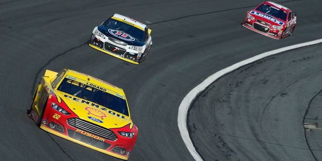 CHARLOTTE, NC - OCTOBER 11: Joey Logano, driver of the #22 Shell Pennzoil Ford, leads a pack of cars during the NASCAR Sprint Cup Series Bank of America 500 at Charlotte Motor Speedway on October 11, 2015 in Charlotte, North Carolina. (Photo by Robert Laberge/NASCAR via Getty Images)