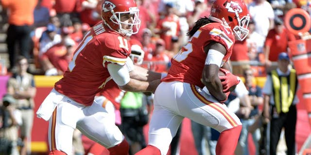 Oct 11, 2015; Kansas City, MO, USA; Kansas City Chiefs quarterback Alex Smith (11) hands off to running back Jamaal Charles (25) during the first half against the Chicago Bears at Arrowhead Stadium. Mandatory Credit: Denny Medley-USA TODAY Sports