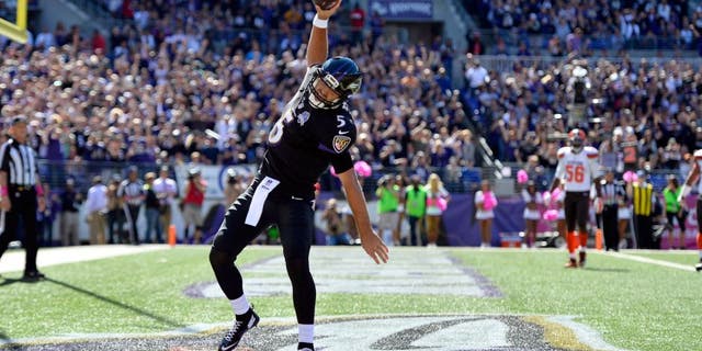 Oct 11, 2015; Baltimore, MD, USA; Baltimore Ravens quarterback Joe Flacco (5) celebrates after scoring a running touchdown during the first quarter against the Cleveland Browns at M&T Bank Stadium. Mandatory Credit: Tommy Gilligan-USA TODAY Sports