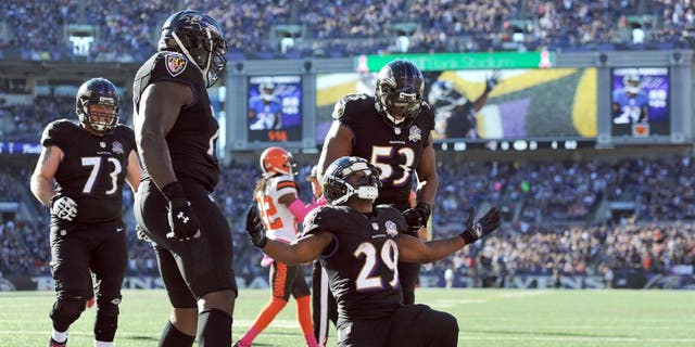 Baltimore Ravens running back Justin Forsett (29) celebrates his touchdown with teammates in the second half of an NFL football game against the Cleveland Browns, Sunday, Oct. 11, 2015, in Baltimore. (AP Photo/Gail Burton)