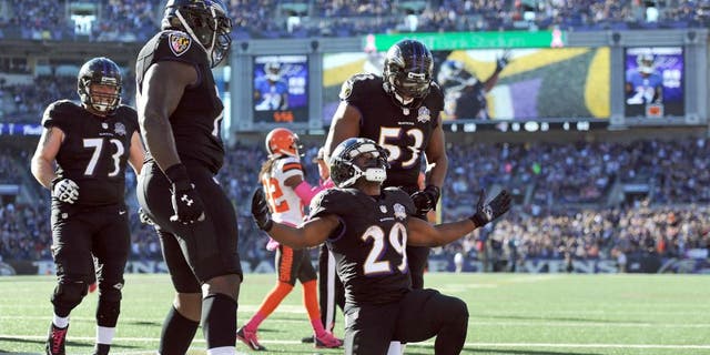 Baltimore Ravens running back Justin Forsett (29) celebrates his touchdown with teammates in the second half of an NFL football game against the Cleveland Browns, Sunday, Oct. 11, 2015, in Baltimore. (AP Photo/Gail Burton)