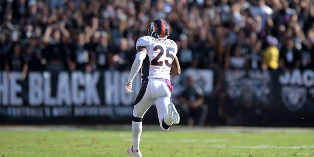 Oct 11, 2015; Oakland, CA, USA; Denver Broncos cornerback Chris Harris Jr. (25) scores on a 75-yard interception return in the fourth quarter against the Oakland Raiders at O.co Coliseum. Mandatory Credit: Kirby Lee-USA TODAY Sports