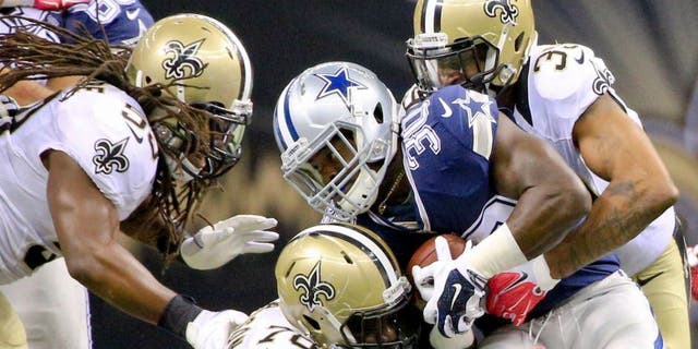 Oct 4, 2015; New Orleans, LA, USA; New Orleans Saints cornerback Brandon Browner (39) and defensive end Bobby Richardson (78) tackle Dallas Cowboys running back Christine Michael (30) during the fourth quarter at the Mercedes-Benz Superdome. The Saints won 26-20 in overtime. Mandatory Credit: Derick E. Hingle-USA TODAY Sports