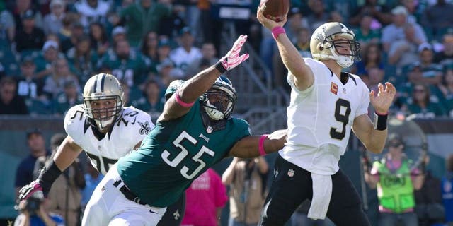 Oct 11, 2015; Philadelphia, PA, USA; New Orleans Saints quarterback Drew Brees (9) passes against the defensive rush of Philadelphia Eagles outside linebacker Brandon Graham (55) during the third quarter at Lincoln Financial Field. Mandatory Credit: Bill Streicher-USA TODAY Sports