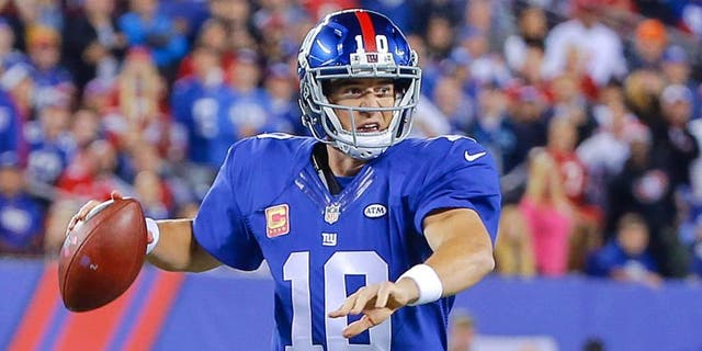 Oct 11, 2015; East Rutherford, NJ, USA; New York Giants quarterback Eli Manning (10) prepares to throw the ball during the first quarter against the San Francisco 49ers at MetLife Stadium. Mandatory Credit: Jim O'Connor-USA TODAY Sports