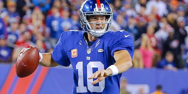 Oct 11, 2015; East Rutherford, NJ, USA; New York Giants quarterback Eli Manning (10) prepares to throw the ball during the first quarter against the San Francisco 49ers at MetLife Stadium. Mandatory Credit: Jim O'Connor-USA TODAY Sports