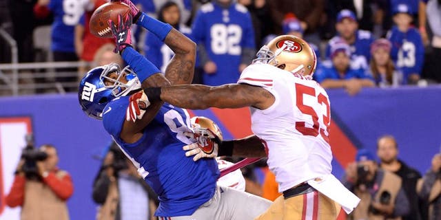 Oct 11, 2015; East Rutherford, NJ, USA; New York Giants tight end Larry Donnell (84) catches the game winning touchdown in front of San Francisco 49ers inside linebacker NaVorro Bowman (53) during the fourth quarter at MetLife Stadium. Mandatory Credit: Robert Deutsch-USA TODAY Sports