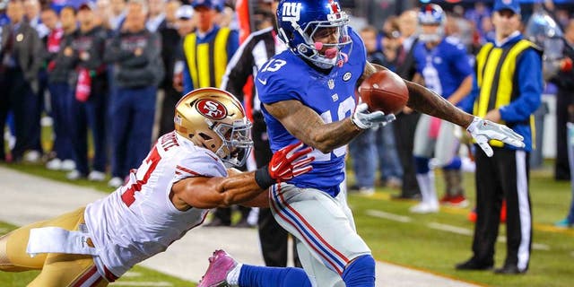 Oct 11, 2015; East Rutherford, NJ, USA; New York Giants wide receiver Odell Beckham (13) scores a touchdown against the San Francisco 49ers during the third quarter at MetLife Stadium. The Giants won 30-27. Mandatory Credit: Jim O'Connor-USA TODAY Sports