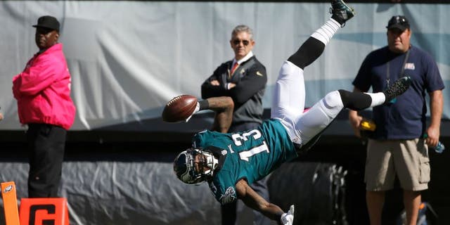 Philadelphia Eagles' Josh Huff flips into the end zone for a touchdown during the first half of an NFL football game against the New Orleans Saints, Sunday, Oct. 11, 2015, in Philadelphia. (AP Photo/Michael Perez)