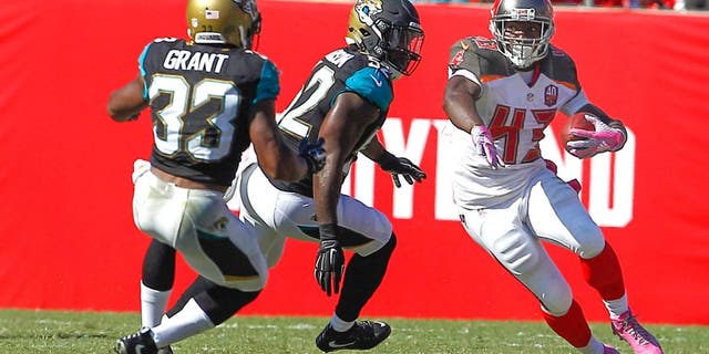 Oct 11, 2015; Tampa, FL, USA;Jacksonville Jaguars running back Corey Grant (33) and James Michael-Johnson (52) chase Tampa Bay Buccaneers running back Bobby Rainey (43) during the second half of an NFL football game at Raymond James Stadium. Tampa won 38-31. Mandatory Credit: Reinhold Matay-USA TODAY Sports